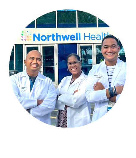 three healthcare professionals standing outside a Northwell Health facility entrance